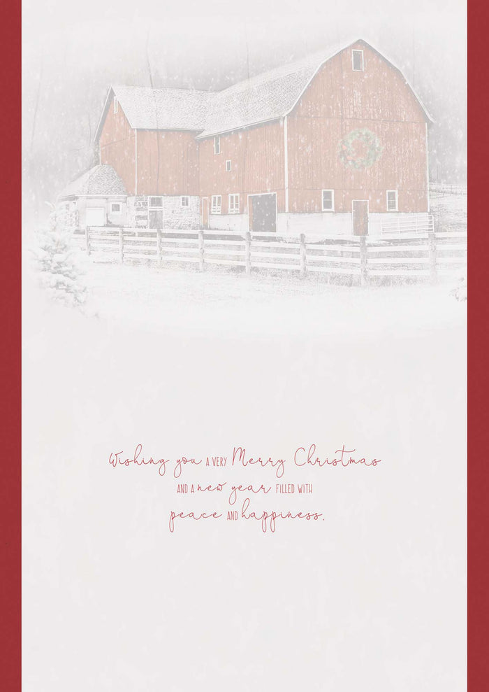 Snowy scene with a barn and festive text on a red border