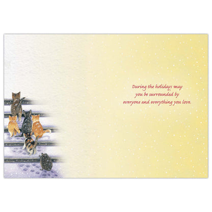 Card with cats on a snowy fence and text on a yellow background