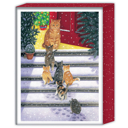 Framed artwork of cats and a hedgehog on a snowy porch with Christmas trees and a red door.