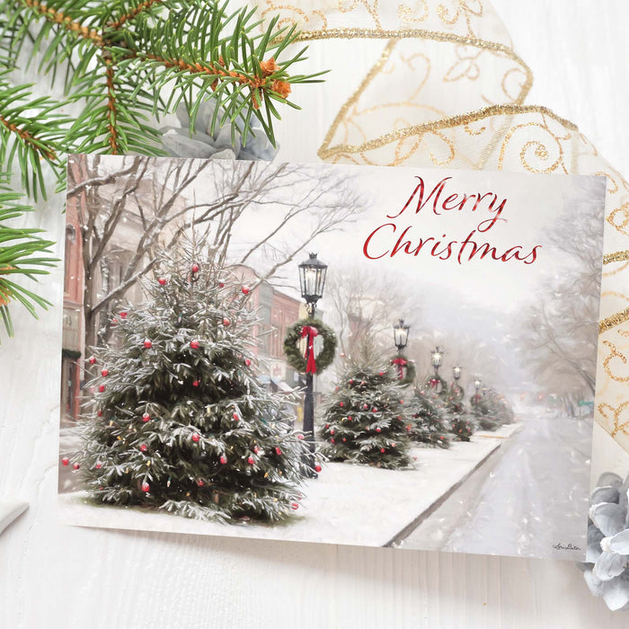 Christmas card with snowy trees and 'Merry Christmas' text, surrounded by festive decorations.
