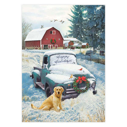 Winter scene with a snow-covered truck and dog in front of a red barn.