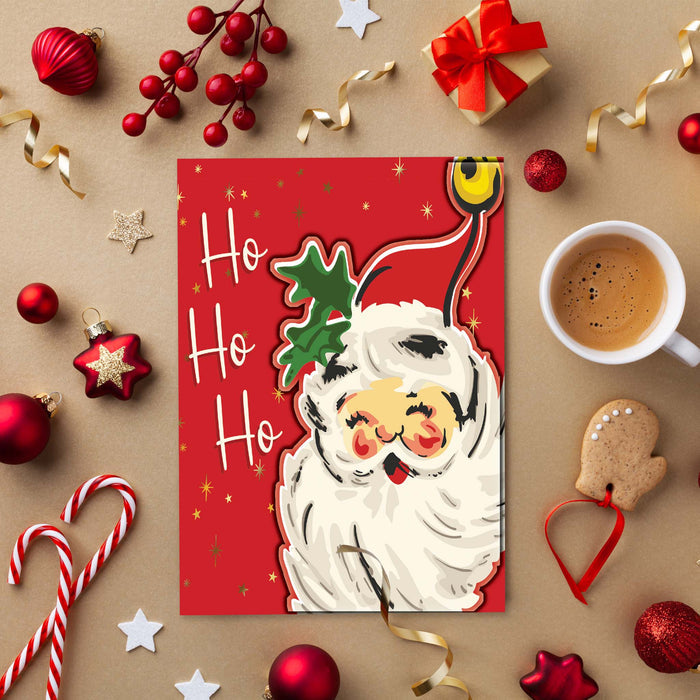 Christmas-themed card with Santa Claus, surrounded by festive decorations and a cup of coffee on a brown background.