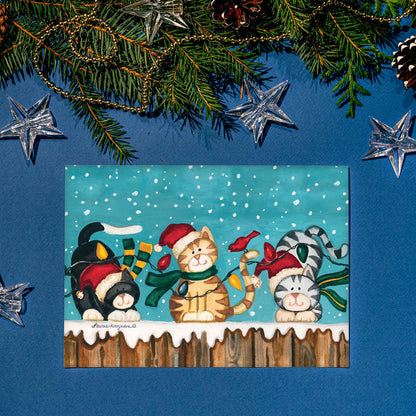 Christmas-themed card with cats and decorations on a blue background