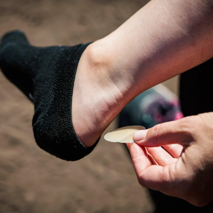 KT Blister Treatment Patch being put on back of foot