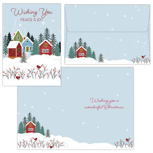 Set of Christmas cards with snowy village scene and envelopes.