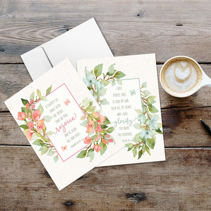 Floral card with envelope on a wooden surface with a cup of coffee.