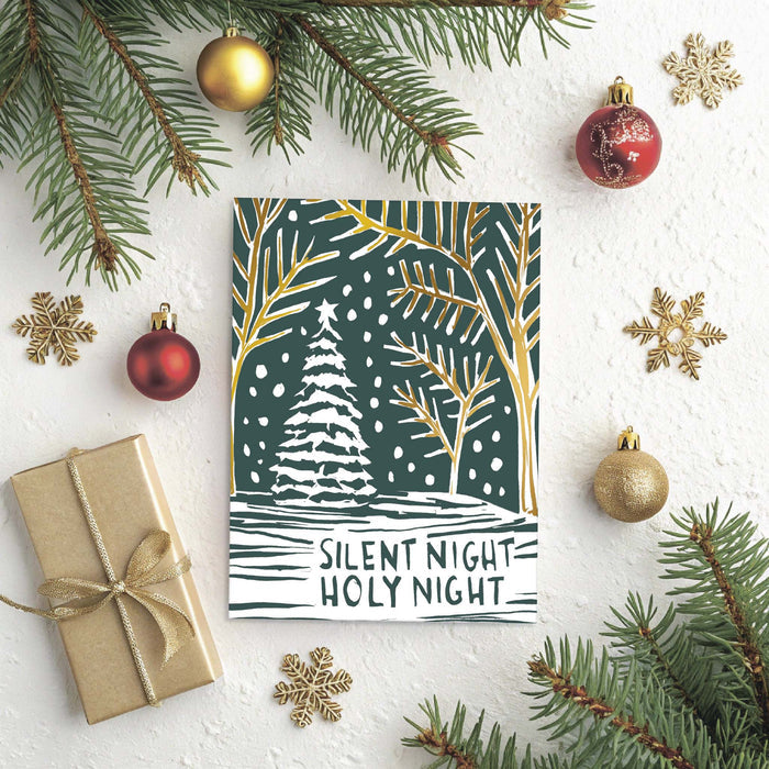 Christmas-themed card with tree design and 'Silent Night Holy Night' text, surrounded by festive decorations on a white background.