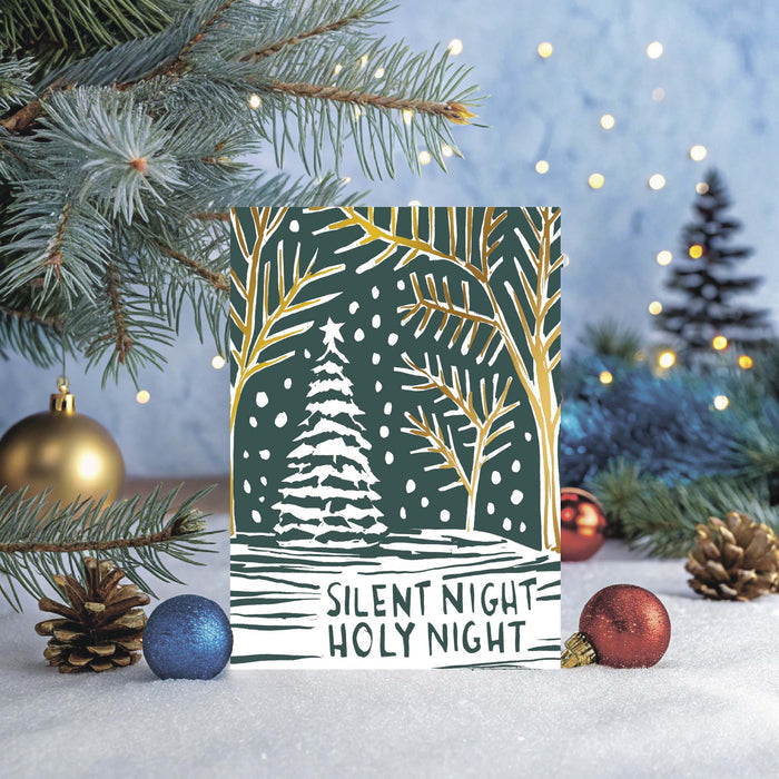 Christmas card with 'Silent Night Holy Night' text and winter scene design, surrounded by festive decorations.