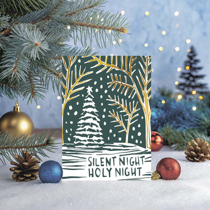 Christmas card with 'Silent Night Holy Night' text and winter scene design, surrounded by festive decorations.