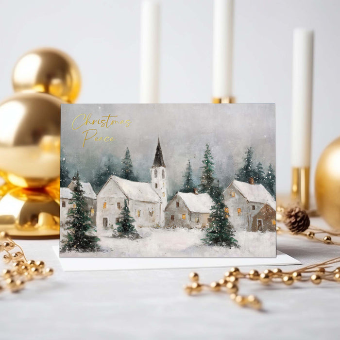 Christmas card with a snowy village scene and 'Christmas Peace' text, surrounded by gold ornaments and candles.