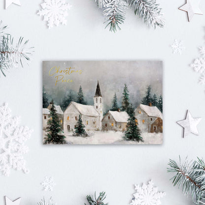 Christmas card with a snowy village scene and 'Christmas Peace' text, surrounded by festive decorations.